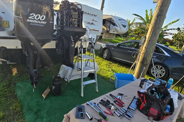  A truck on the grass supports operations for Marine Kings of Miami and boat maintenance services.