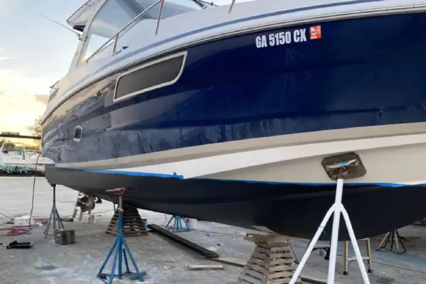 On the ground, a vessel is repaired through boat repair Miami by Marine Kings of Miami in Miami, Florida.