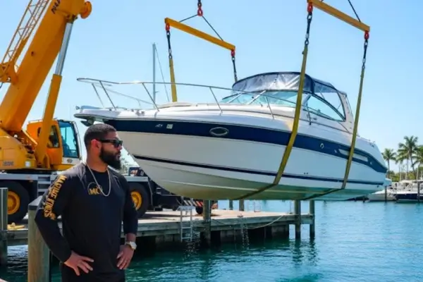  Standing near the water, a technician from Marine Kings of Miami prepares for boat repair Miami.