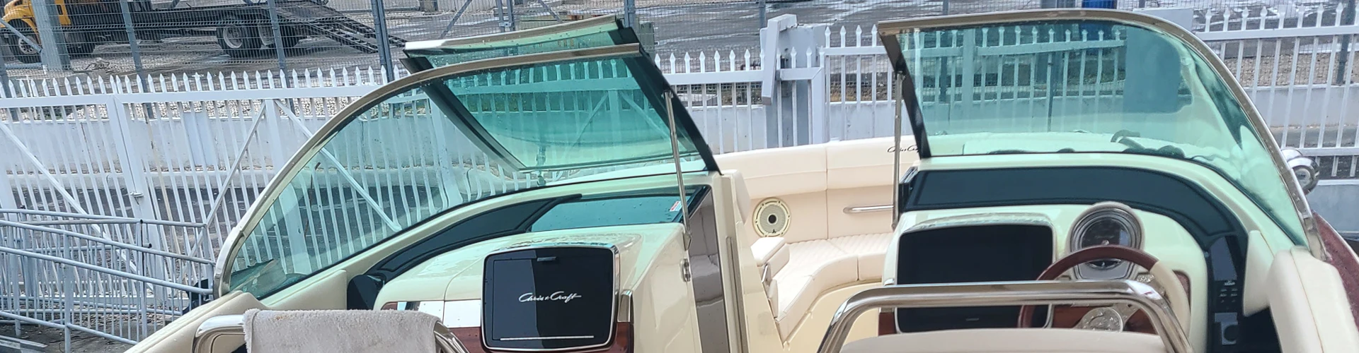  A yard-stored boat with an open door is serviced by Marine Kings of Miami with boat repair Miami.