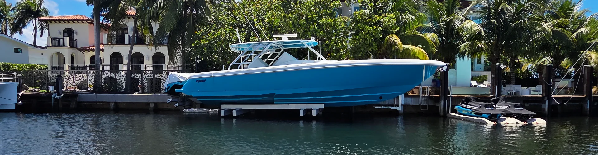 A docked boat near palm trees is maintained by Marine Kings of Miami with boat maintenance services in Miami, Florida.