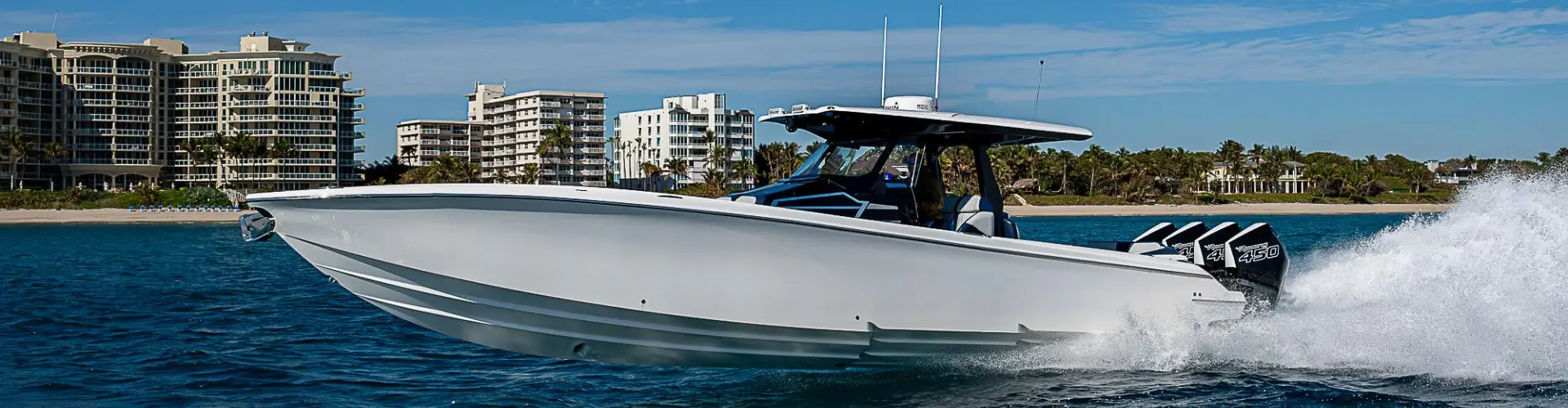  A white boat moving fast reflects boat maintenance services completed by Marine Kings of Miami in Miami, Florida.