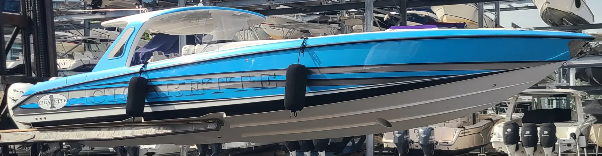 Multiple cranes lift a vessel for boat maintenance services by Marine Kings of Miami.