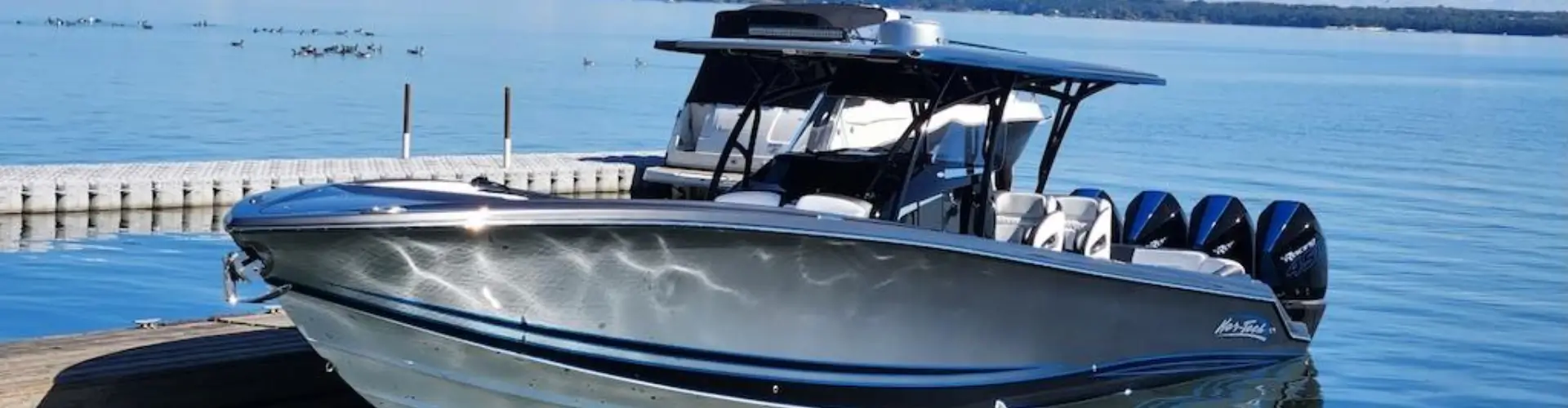 A boat docked by the pier is serviced by Marine Kings of Miami with boat maintenance services in Miami, Florida.