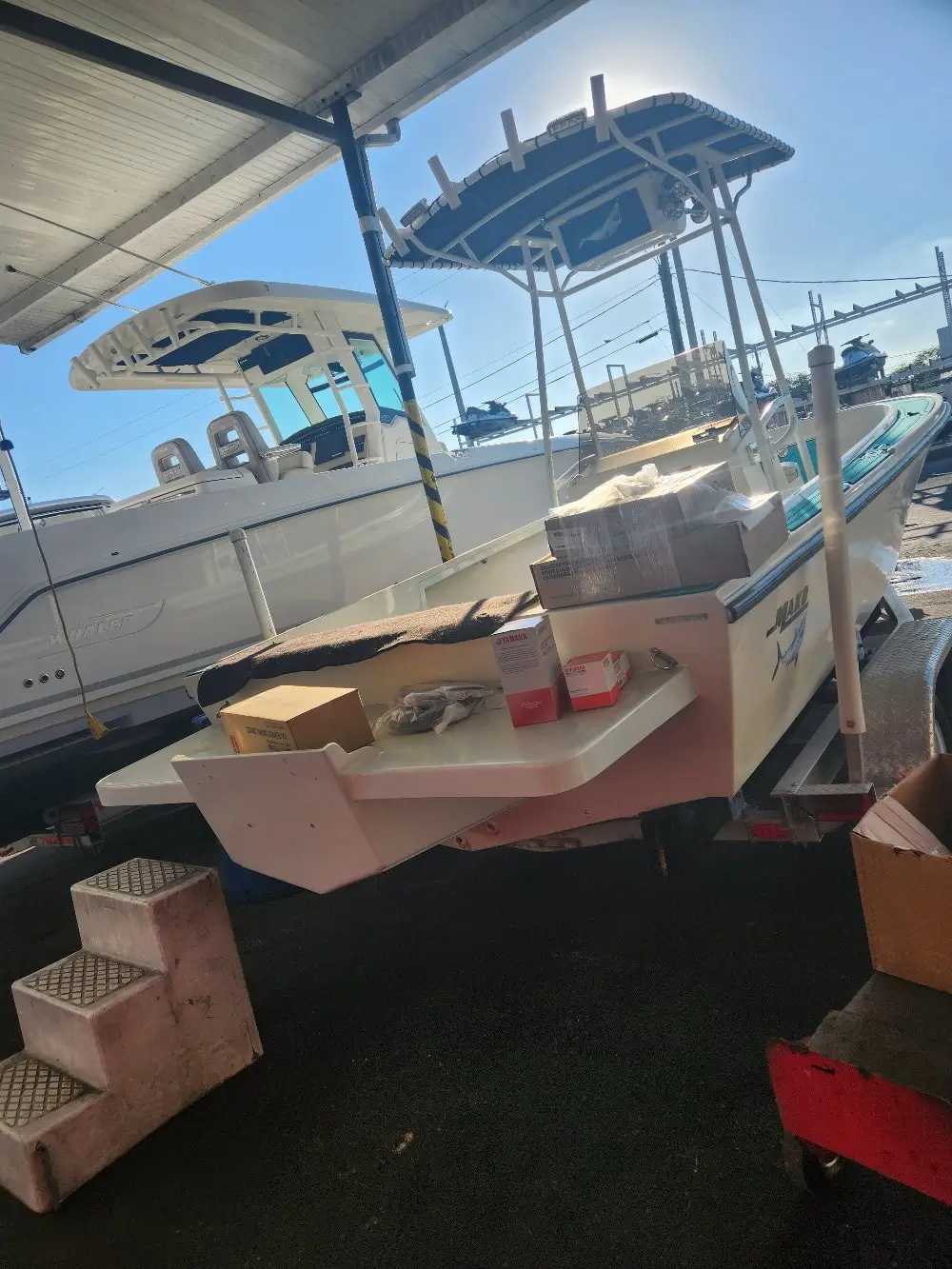 A boat in the water with cargo is supported by Marine Kings of Miami with boat maintenance services in Miami, Florida.