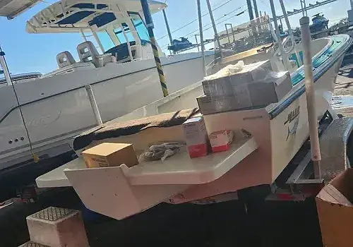 A boat in the water with cargo is supported by Marine Kings of Miami with boat maintenance services in Miami, Florida.