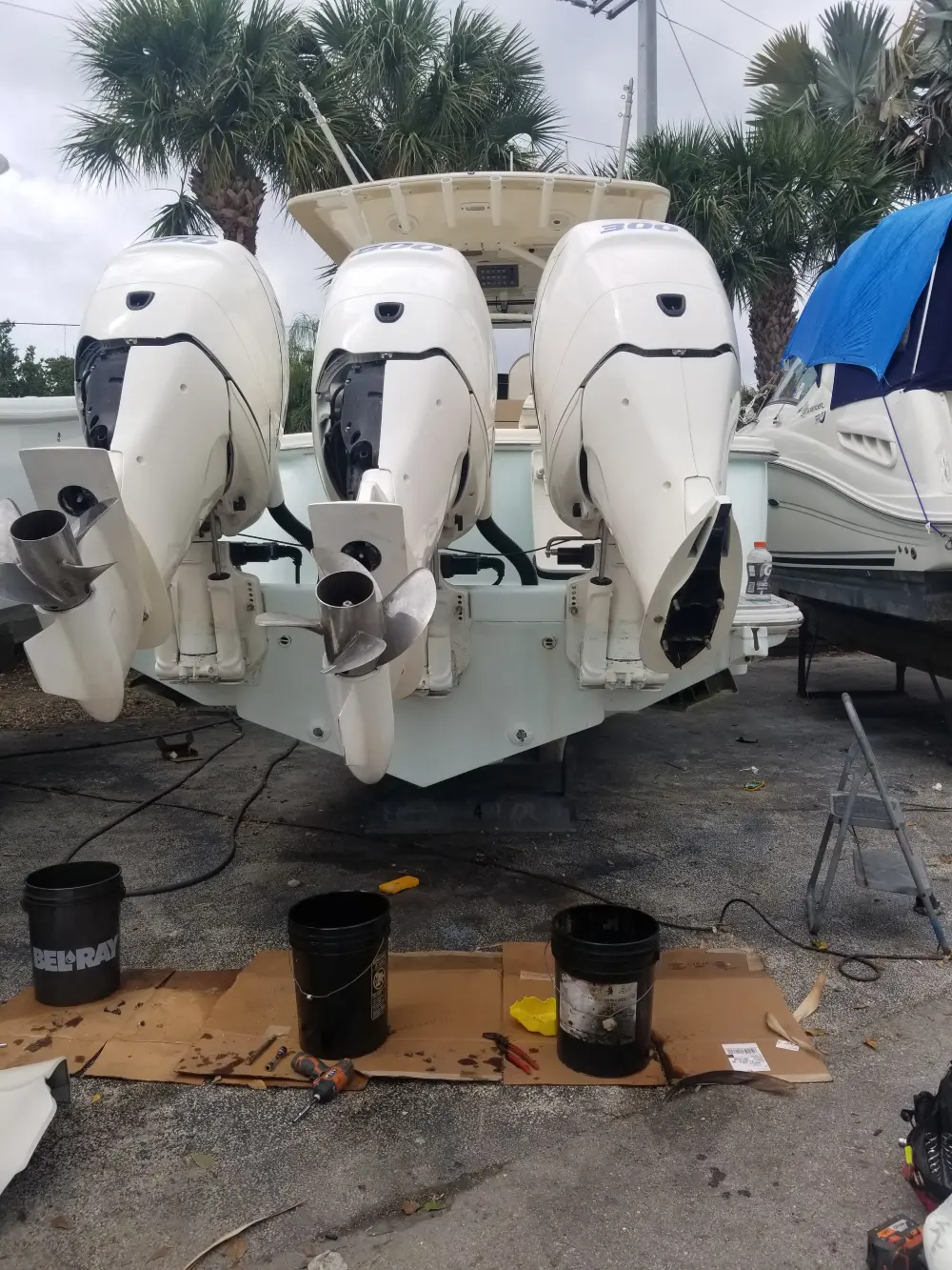  Two engines on the ground are serviced by Marine Kings of Miami with outboard engine service in Miami, Florida.