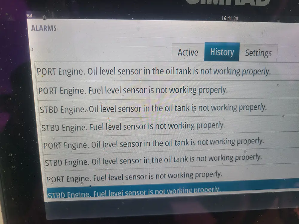An electronic device in hand is tested by Marine Kings of Miami with marine electrical troubleshooting.