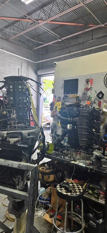 Trucks in a garage support operations for Marine Kings of Miami and boat repair Miami.