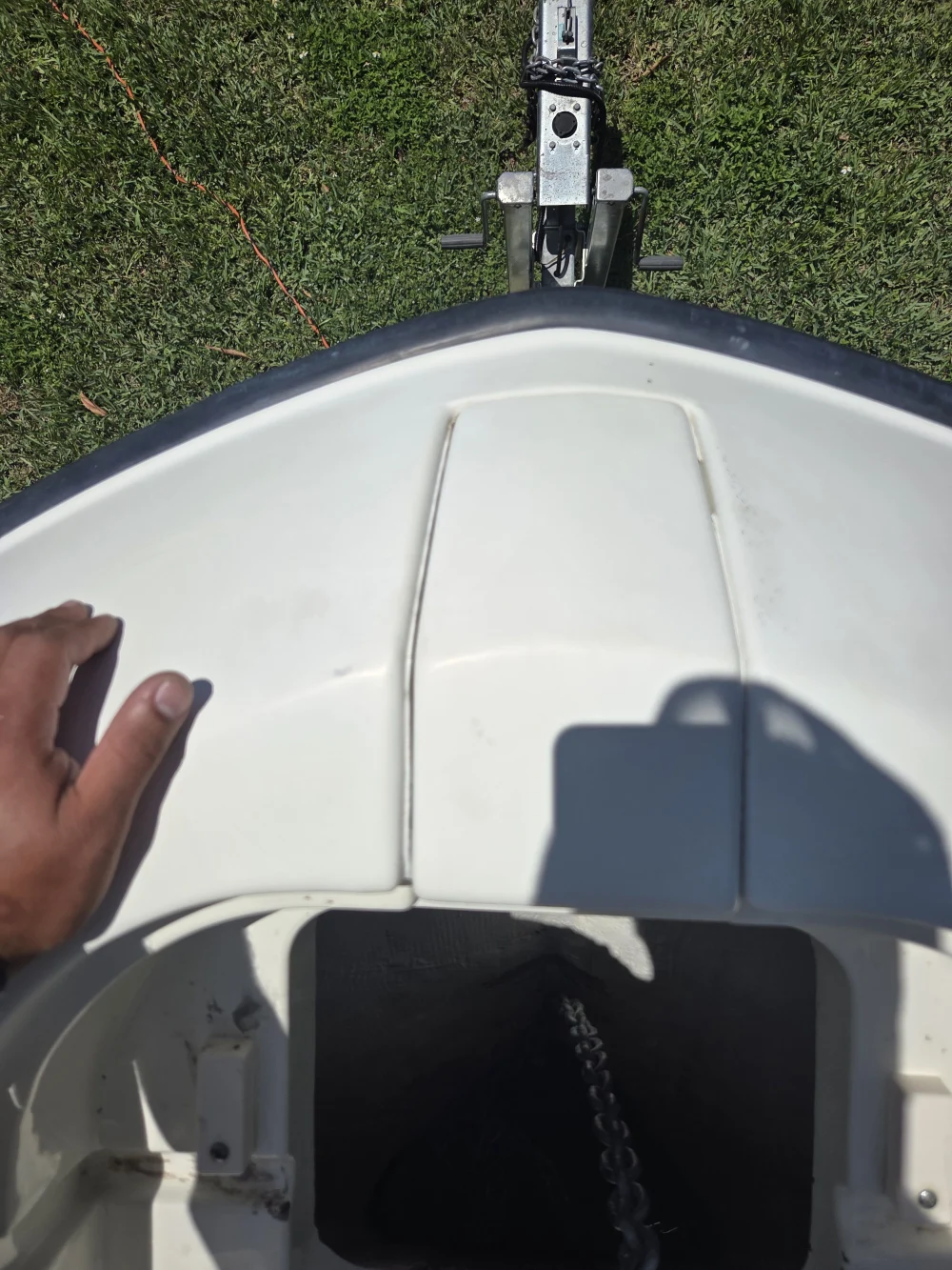  A hand along the boat edge shows inspection by Marine Kings of Miami with boat maintenance services in Miami, Florida.