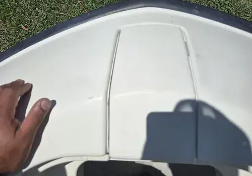  A hand along the boat edge shows inspection by Marine Kings of Miami with boat maintenance services in Miami, Florida.