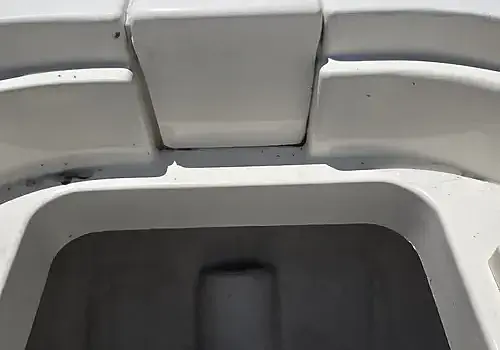 A white boat with the seat raised is serviced by Marine Kings of Miami with boat repair Miami.