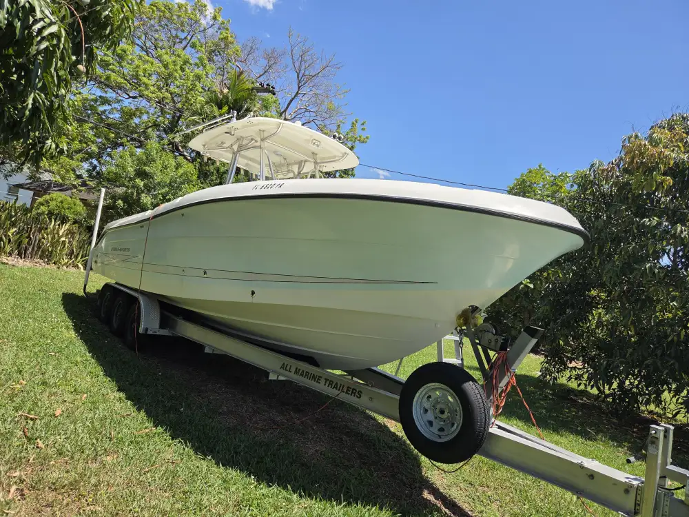 A trailer-mounted boat is handled by Marine Kings of Miami with boat repair Miami.