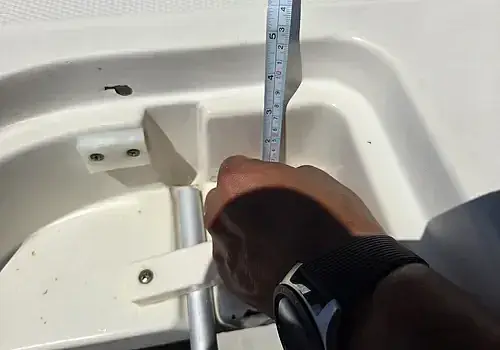 Width measurements are taken by Marine Kings of Miami during boat maintenance services in Miami, Florida.