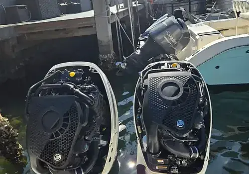 Two boats near a dock are serviced by Marine Kings of Miami with boat maintenance services.