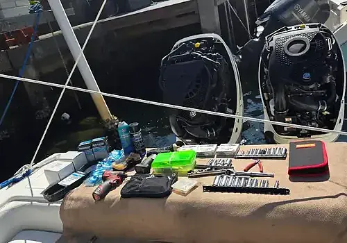 Seated at the back, a technician from Marine Kings of Miami works on boat maintenance services.