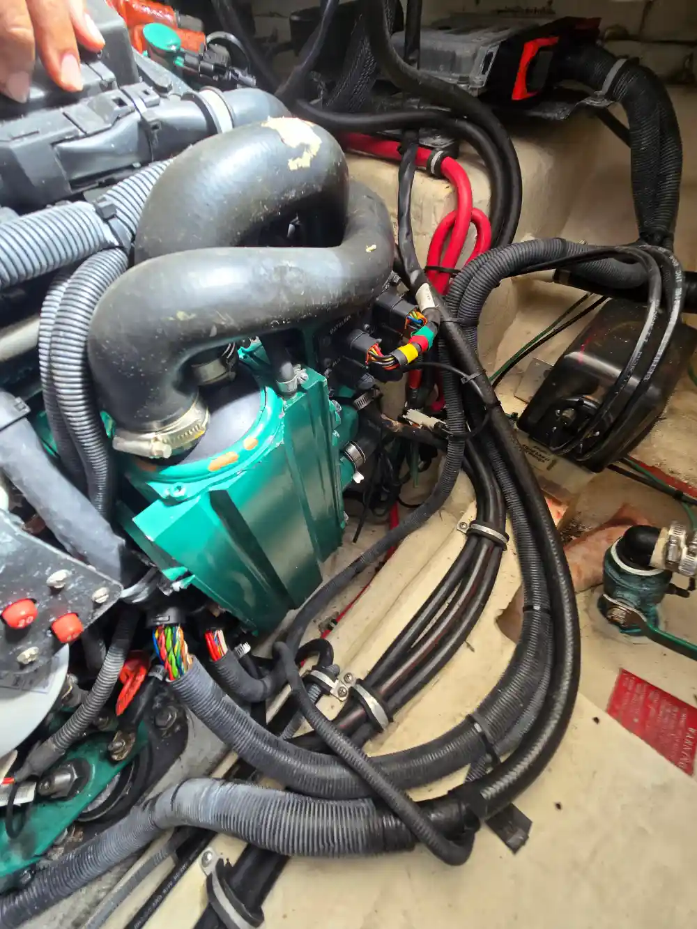  A small engine with wiring is tested by Marine Kings of Miami using marine engine diagnostics.