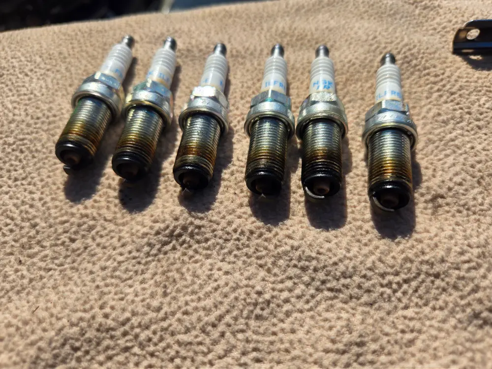 Spark components on the carpet are examined by Marine Kings of Miami during boat repair Miami.