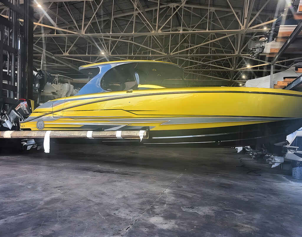 A yellow boat in the garage is maintained by Marine Kings of Miami with boat repair Miami in Miami, Florida.