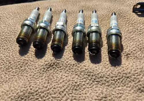 Spark components on the carpet are examined by Marine Kings of Miami during boat repair Miami.