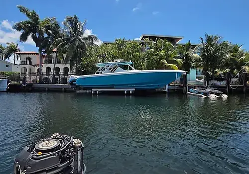  A docked boat near homes is serviced by Marine Kings of Miami with boat maintenance services.