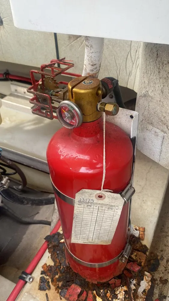 Fire safety equipment is checked by Marine Kings of Miami during boat maintenance services in Miami, Florida.