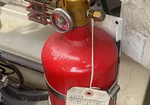 Fire safety equipment is checked by Marine Kings of Miami during boat maintenance services in Miami, Florida.