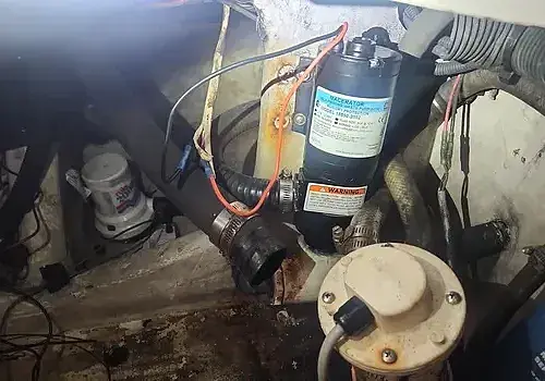 A small air conditioner is installed by Marine Kings of Miami using electrical services in Miami, Florida.