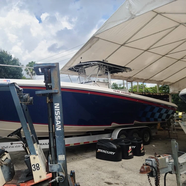  A covered boat is maintained by Marine Kings of Miami with boat maintenance services.