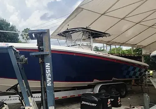  A covered boat is maintained by Marine Kings of Miami with boat maintenance services.