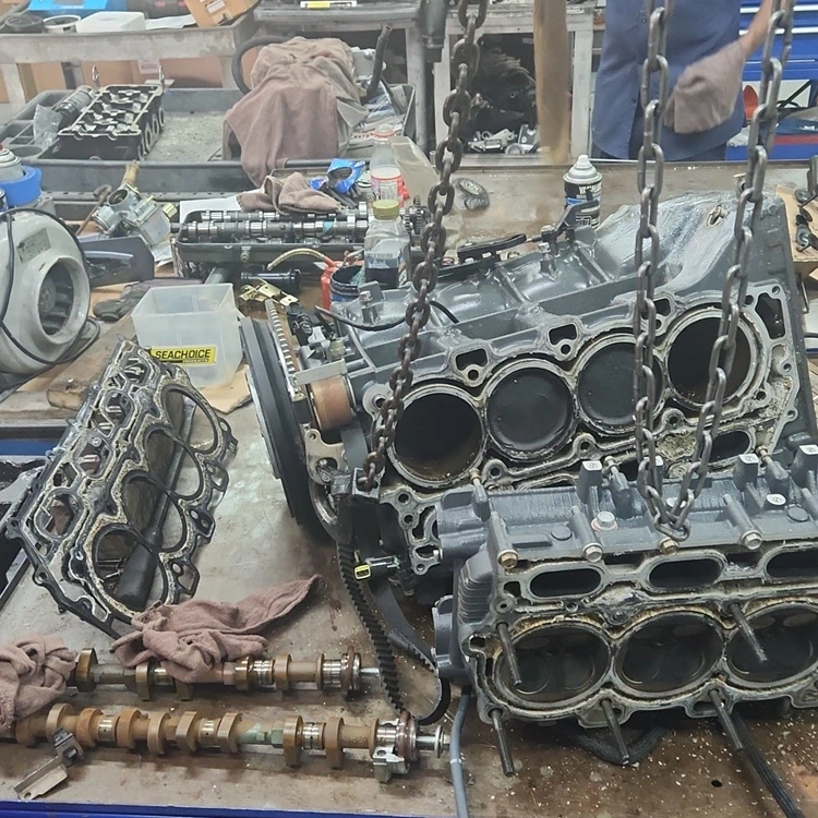 Engine parts in a workshop are used by Marine Kings of Miami for marine engine diagnostics in Miami, Florida.