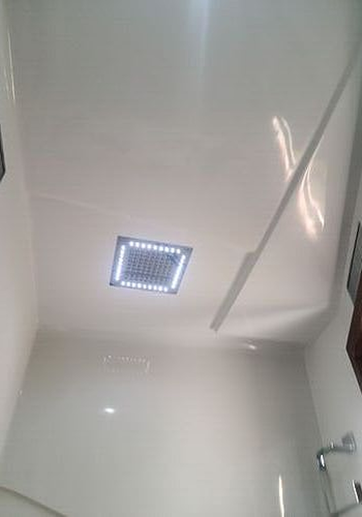 A bathroom with wood floors is maintained by Marine Kings of Miami with plumbing services.