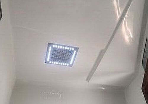 A bathroom with wood floors is maintained by Marine Kings of Miami with plumbing services.