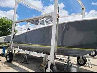 A trailer-towed vessel is moved for boat maintenance services by Marine Kings of Miami.