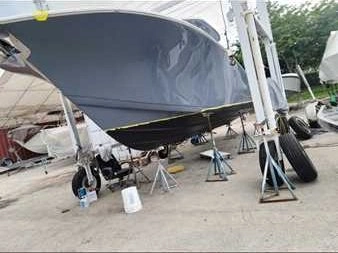  A boat in the parking lot is serviced by Marine Kings of Miami with boat maintenance services.