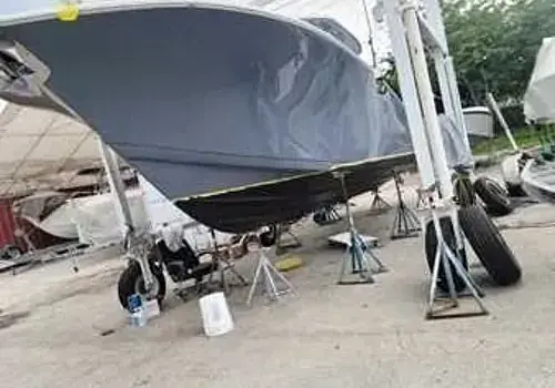  A boat in the parking lot is serviced by Marine Kings of Miami with boat maintenance services.