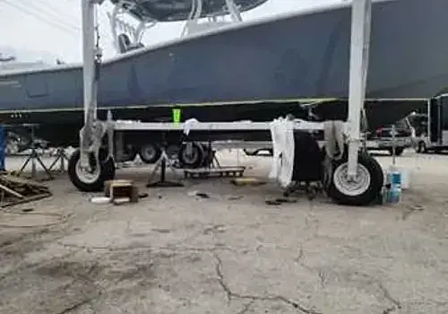 A boat being towed on land is transported for boat repair Miami by Marine Kings of Miami in Miami, Florida.