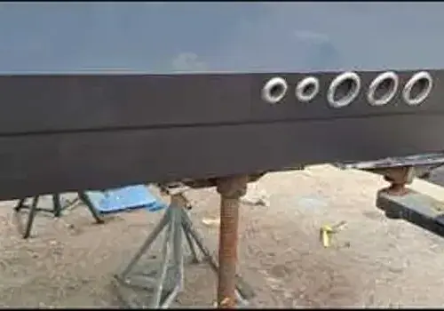 A black boat with wheels is handled by Marine Kings of Miami with boat maintenance services.