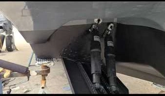 Painting the side of a boat is part of boat maintenance services by Marine Kings of Miami in Miami, Florida.