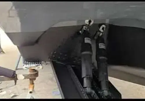 Painting the side of a boat is part of boat maintenance services by Marine Kings of Miami in Miami, Florida.