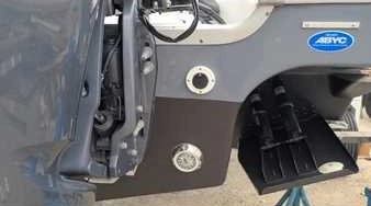 Removing a bumper with tools reflects mechanical skills used by Marine Kings of Miami for boat repair Miami.