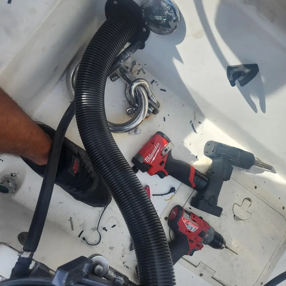 A hose being positioned supports boat repair Miami completed by Marine Kings of Miami.