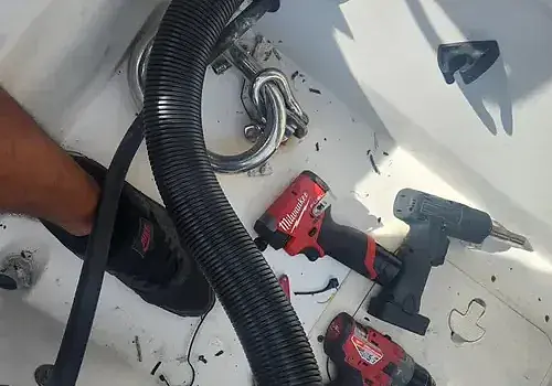 A hose being positioned supports boat repair Miami completed by Marine Kings of Miami.