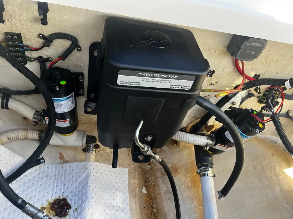 A small motor with wires is tested by Marine Kings of Miami using marine engine diagnostics.