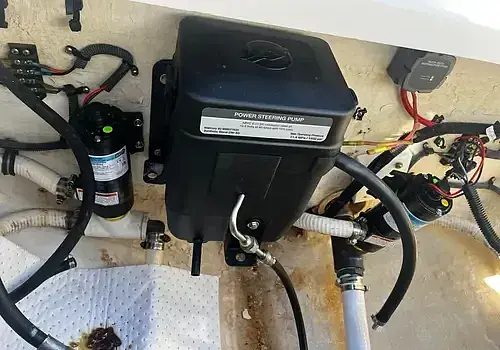 A small motor with wires is tested by Marine Kings of Miami using marine engine diagnostics.