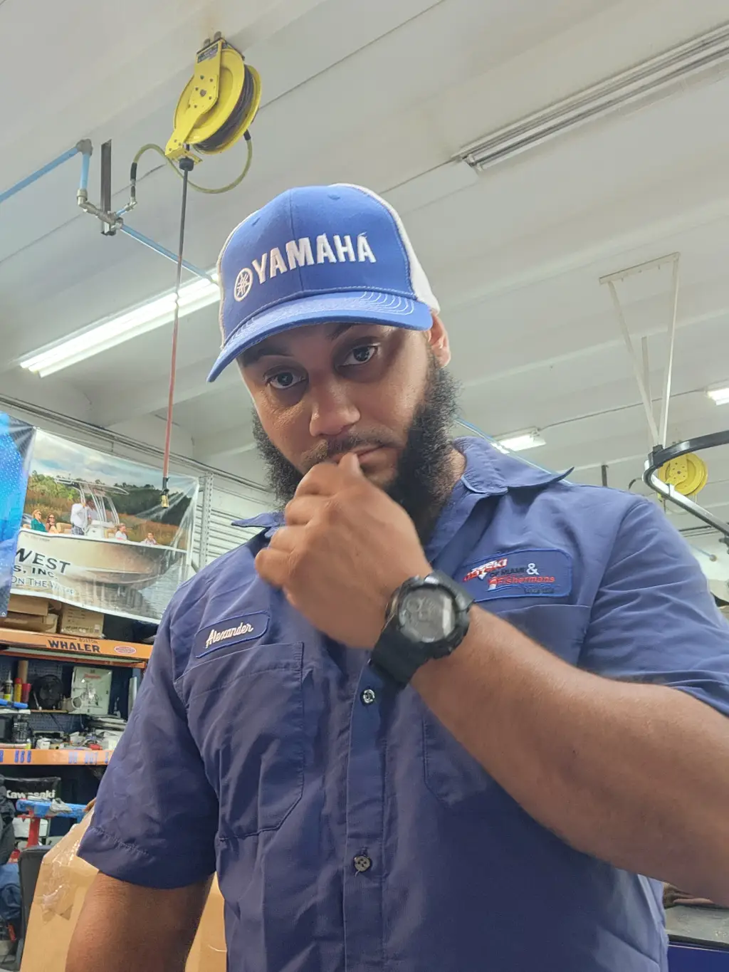 A blue cap worn by Alexander highlights boat maintenance services from Marine Kings of Miami in Miami, Florida.