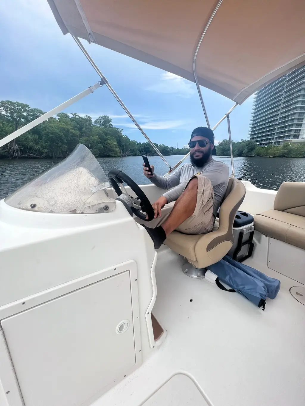  Alexander is seated in a boat supported by Marine Kings of Miami boat maintenance services.