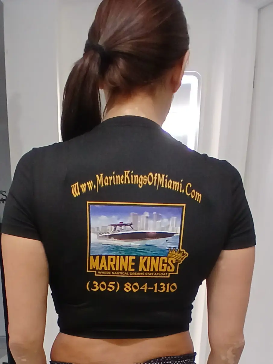 Nicolle wears a branded shirt representing boat repair Miami by Marine Kings of Miami.