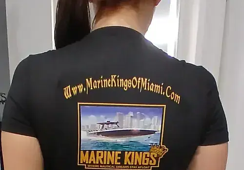 Nicolle wears a branded shirt representing boat repair Miami by Marine Kings of Miami.