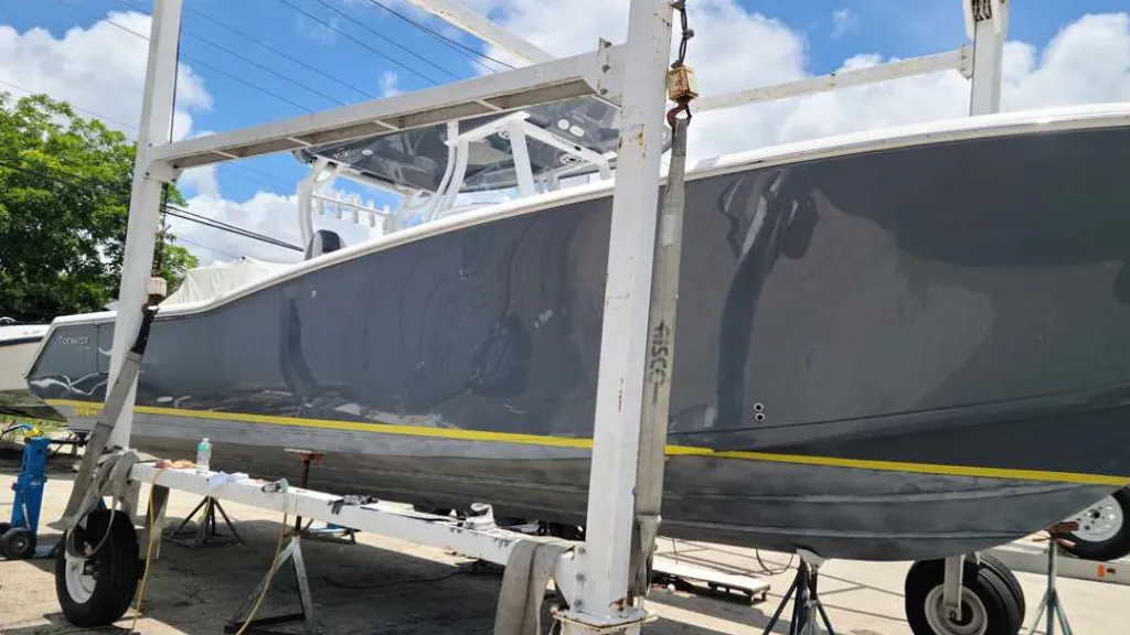 A boat is lifted by a crane as Marine Kings of Miami prepares it for boat repair Miami.